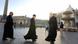 Three priests cross St. Peter's Square at the Vatican, Friday, Oct. 18, 2002. The Vatican rejected the U.S. Roman Catholic Church's new sexual abuse policy Friday, saying the sweeping zero-tolerance crackdown needed to be revised because elements conflict with universal church law.