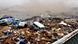 Cars and other debris swept away by tsunami waves